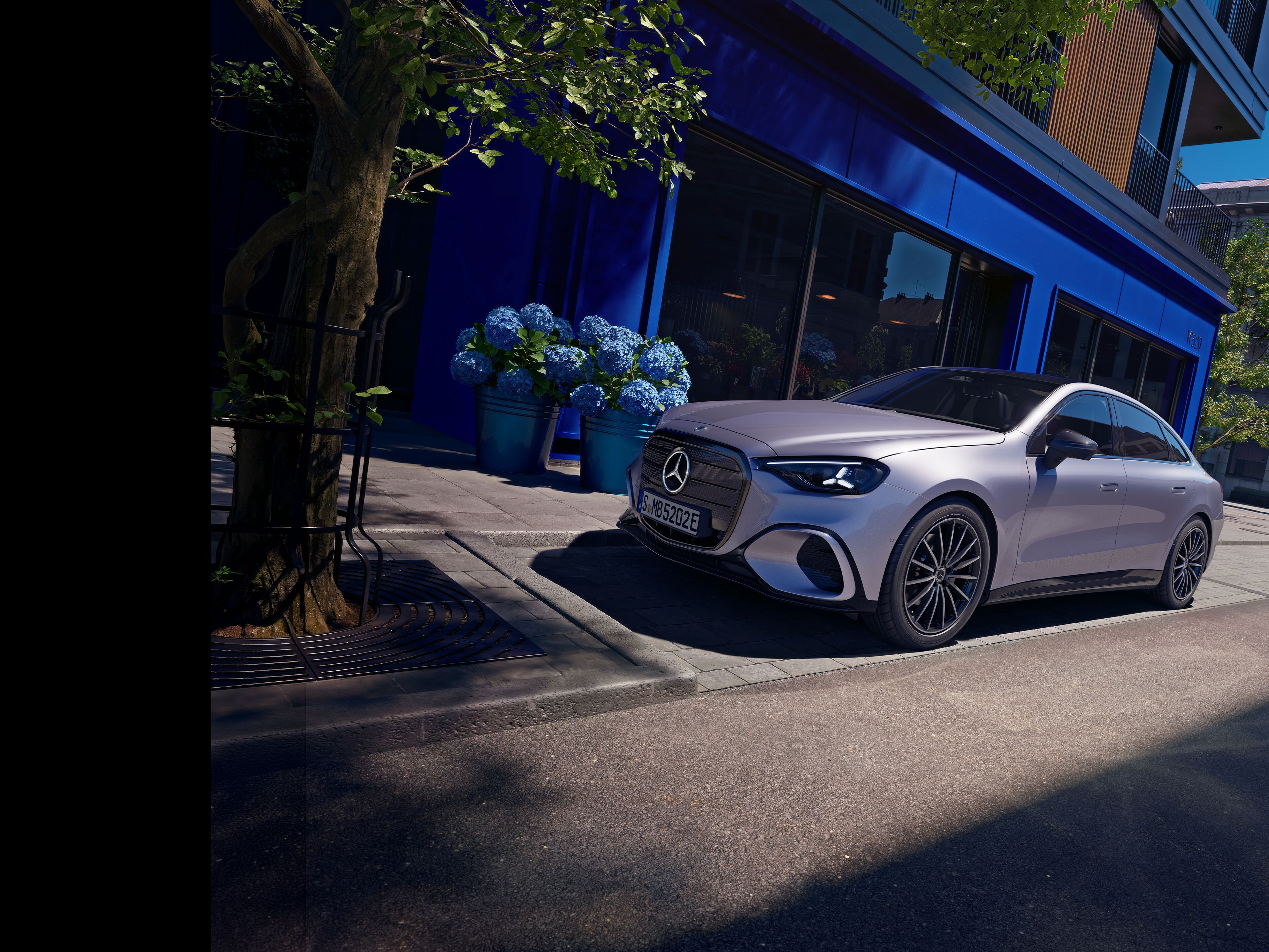 C-Klasse | Mercedes-Benz Magazine Den elektriske C-Klasse fra Mercedes-Benz parkeret foran en butik.